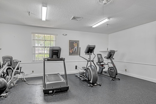 12003 Poinciana Blvd Unit 102, Royal Palm Beach, FL 33411 - exercise room with a textured ceiling