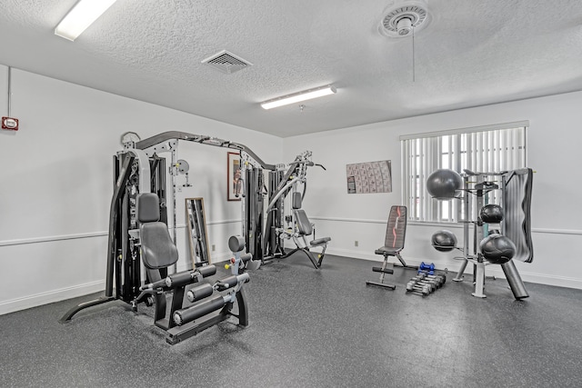 12003 Poinciana Blvd Unit 102, Royal Palm Beach, FL 33411 - workout area featuring a textured ceiling and baseboards