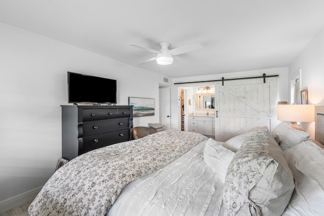 1045 Circle Ter E Unit D, Delray Beach, FL 33445 - carpeted bedroom featuring a barn door, baseboards, and ceiling fan