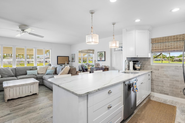 1045 Circle Ter E Unit D, Delray Beach, FL 33445 - kitchen with a sink, stainless steel dishwasher, a peninsula, white cabinetry, and ceiling fan