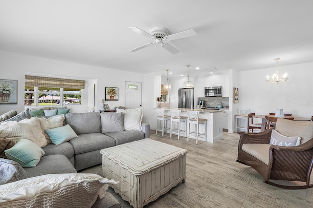 1045 Circle Ter E Unit D, Delray Beach, FL 33445 - living room featuring a chandelier, light wood-style flooring, ceiling fan, and recessed lighting