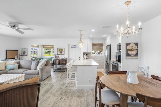 1045 Circle Ter E Unit D, Delray Beach, FL 33445 - living area featuring light wood-type flooring, recessed lighting, a chandelier, and a ceiling fan