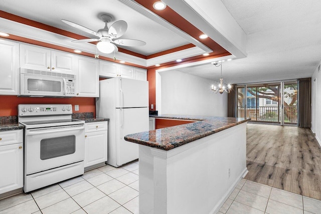 2008 S Federal Hwy Unit 206, Boynton Beach, FL 33435 - kitchen with white appliances, a raised ceiling, white cabinetry, light tile patterned flooring, and recessed lighting