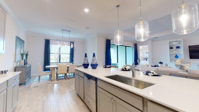 1417 SE Crosswood Way, Port Saint Lucie, FL 34984 - kitchen with dishwasher, a sink, open floor plan, light countertops, and ornamental molding