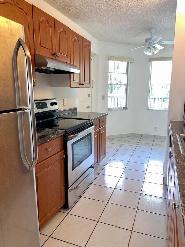 650 SW 124th Ter Unit 202P, Pembroke Pines, FL 33027 - kitchen featuring appliances with stainless steel finishes, under cabinet range hood, brown cabinets, ceiling fan, and a textured ceiling