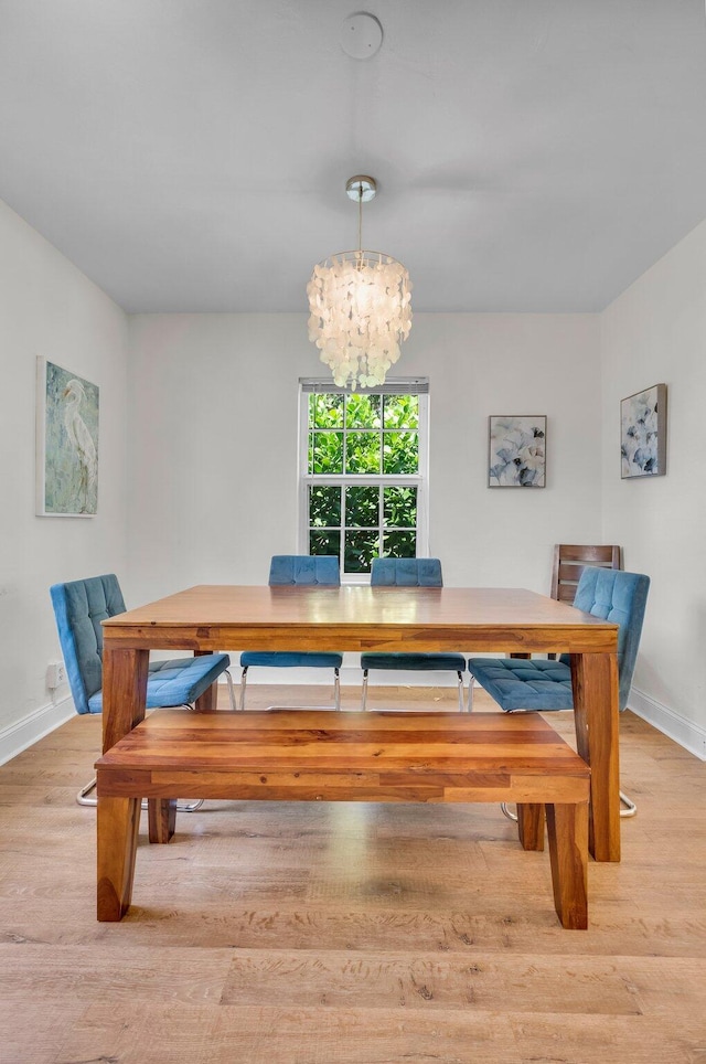 301 SW 1st Ave, Delray Beach, FL 33444 - dining room with a chandelier, wood finished floors, and baseboards