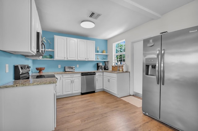 301 SW 1st Ave, Delray Beach, FL 33444 - kitchen with appliances with stainless steel finishes, open shelves, light wood-style flooring, and white cabinets