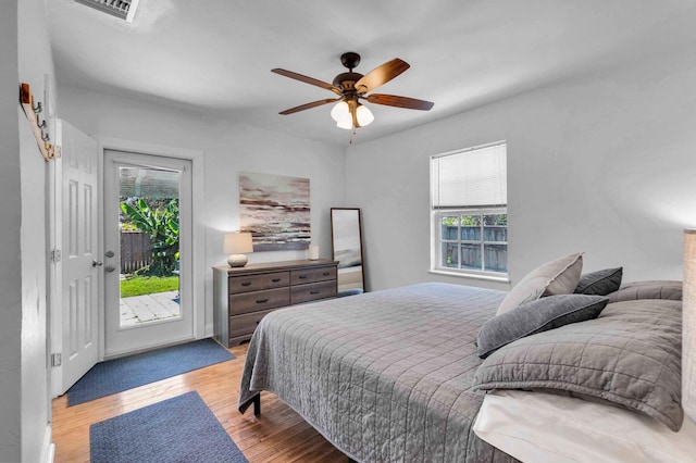 301 SW 1st Ave, Delray Beach, FL 33444 - bedroom featuring access to outside, wood finished floors, and a ceiling fan