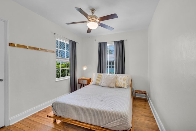 301 SW 1st Ave, Delray Beach, FL 33444 - bedroom with light wood-type flooring, baseboards, and a ceiling fan