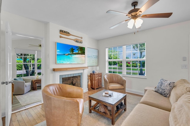 301 SW 1st Ave, Delray Beach, FL 33444 - living room with ceiling fan, a fireplace, plenty of natural light, and wood finished floors