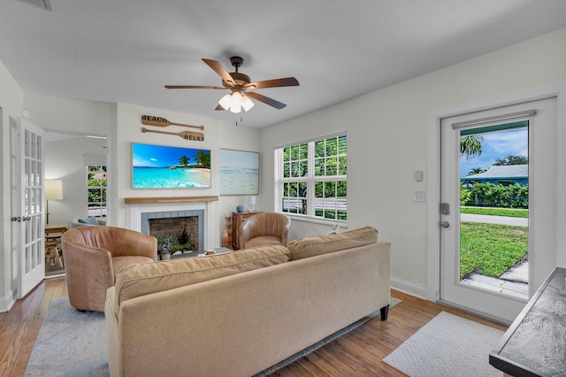 301 SW 1st Ave, Delray Beach, FL 33444 - living area with a fireplace, hardwood / wood-style floors, baseboards, and a ceiling fan