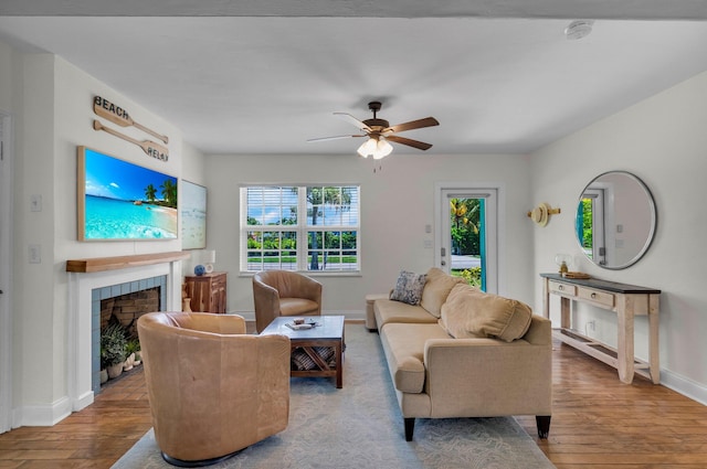 301 SW 1st Ave, Delray Beach, FL 33444 - living room featuring baseboards, wood finished floors, ceiling fan, and a fireplace