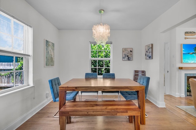 301 SW 1st Ave, Delray Beach, FL 33444 - dining room with healthy amount of natural light, a chandelier, and light wood-style flooring