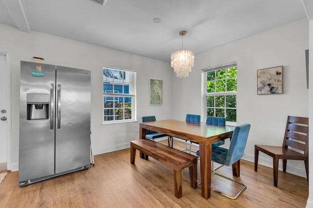 301 SW 1st Ave, Delray Beach, FL 33444 - dining area featuring light wood-style flooring, baseboards, and a chandelier