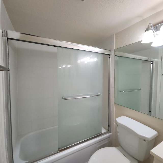 173 Kent J, West Palm Beach, FL 33417 - bathroom with bath / shower combo with glass door, toilet, and a textured ceiling