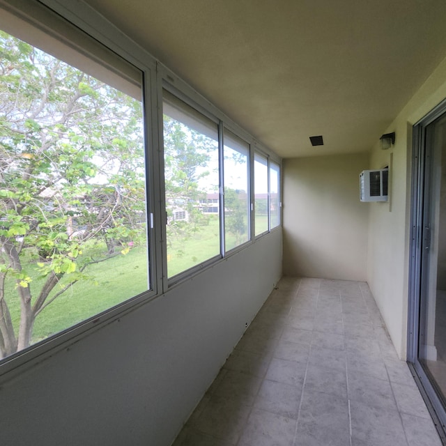 173 Kent J, West Palm Beach, FL 33417 - unfurnished sunroom featuring a wall mounted air conditioner and tile patterned flooring