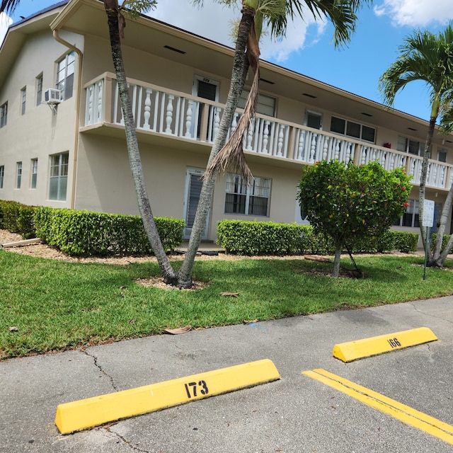 173 Kent J, West Palm Beach, FL 33417 - view of property featuring uncovered parking and cooling unit