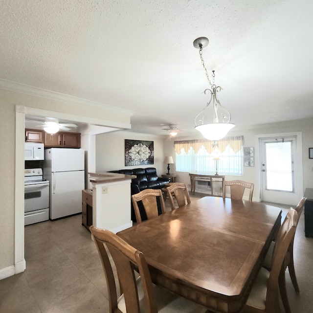 173 Kent J, West Palm Beach, FL 33417 - dining area featuring a ceiling fan, a textured ceiling, ornamental molding, and light tile patterned floors