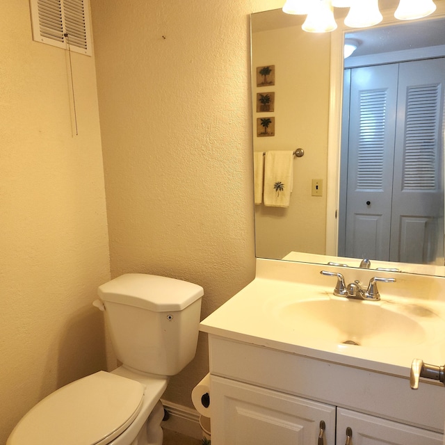 173 Kent J, West Palm Beach, FL 33417 - half bath with toilet, a textured wall, and vanity
