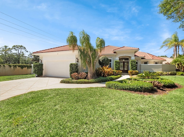18771 Misty Lake Dr, Jupiter, FL 33458 - mediterranean / spanish-style house featuring a tile roof, stucco siding, concrete driveway, a garage, and french doors