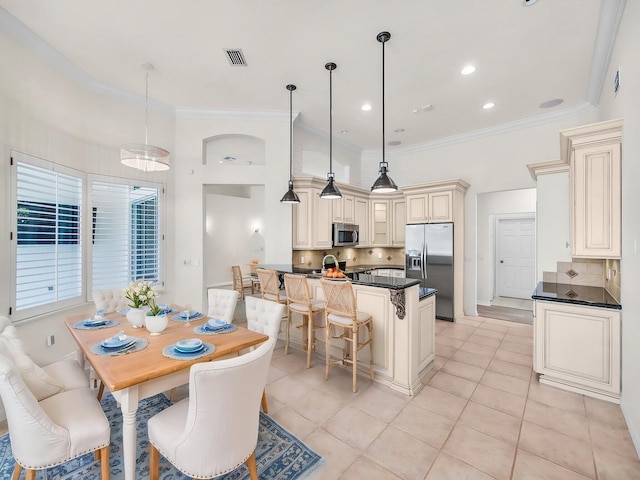 18771 Misty Lake Dr, Jupiter, FL 33458 - dining area featuring light tile patterned floors and crown molding