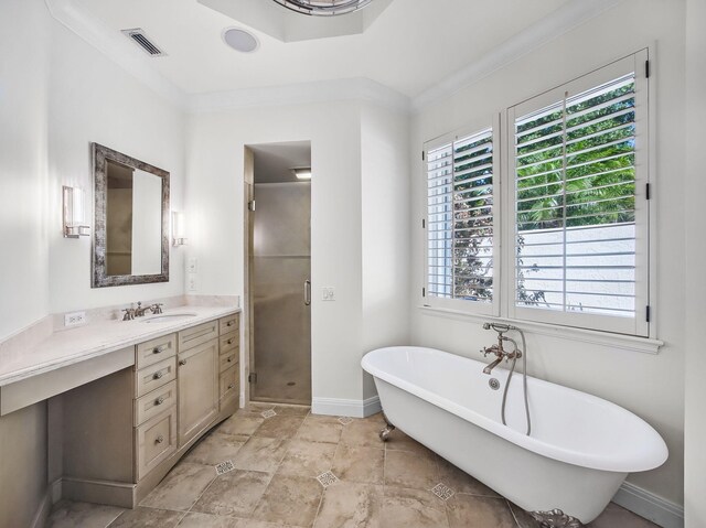 18771 Misty Lake Dr, Jupiter, FL 33458 - full bathroom with vanity, a stall shower, a freestanding tub, baseboards, and crown molding