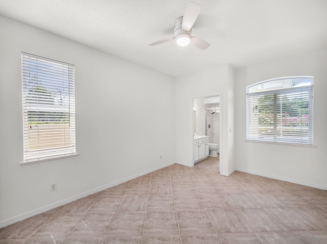 18771 Misty Lake Dr, Jupiter, FL 33458 - unfurnished bedroom with ensuite bathroom, baseboards, and a ceiling fan