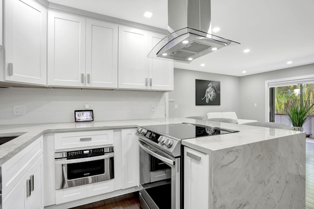 545 Trace Cir Unit 106, Deerfield Beach, FL 33441 - kitchen with appliances with stainless steel finishes, island exhaust hood, a peninsula, backsplash, and recessed lighting