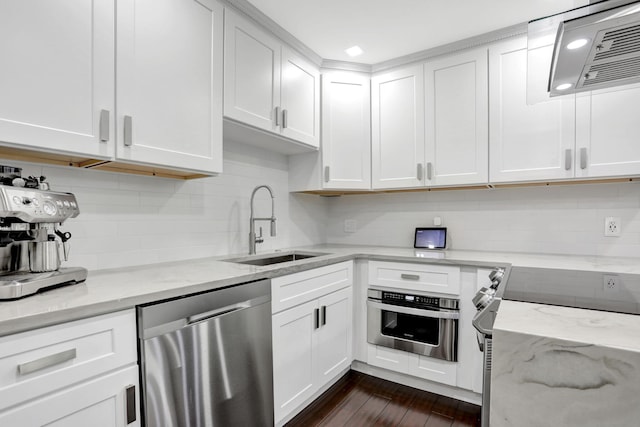 545 Trace Cir Unit 106, Deerfield Beach, FL 33441 - kitchen featuring stainless steel appliances, a sink, extractor fan, white cabinetry, and decorative backsplash