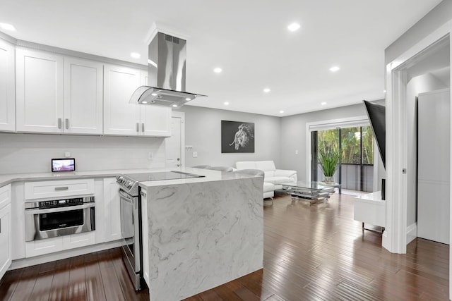 545 Trace Cir Unit 106, Deerfield Beach, FL 33441 - kitchen with stainless steel appliances, island exhaust hood, open floor plan, white cabinets, and light stone counters