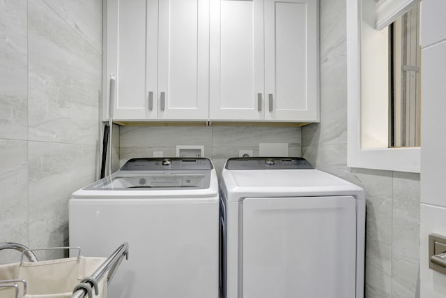 545 Trace Cir Unit 106, Deerfield Beach, FL 33441 - laundry area with tile walls, cabinet space, and washer and dryer