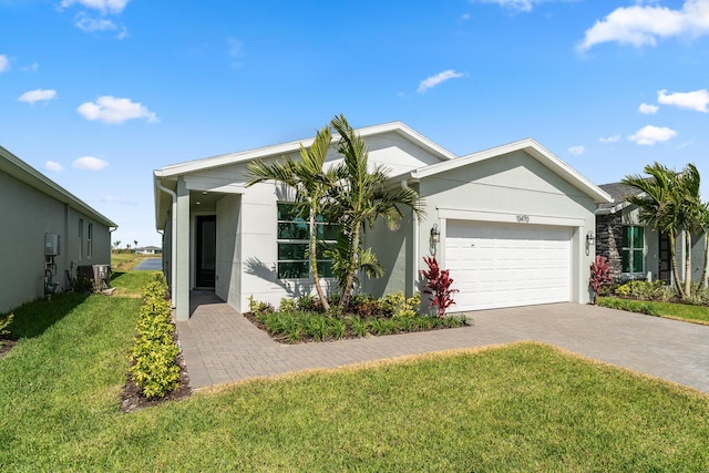 single story home with a front yard, a garage, decorative driveway, and stucco siding