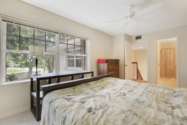 bedroom with baseboards and ensuite bath