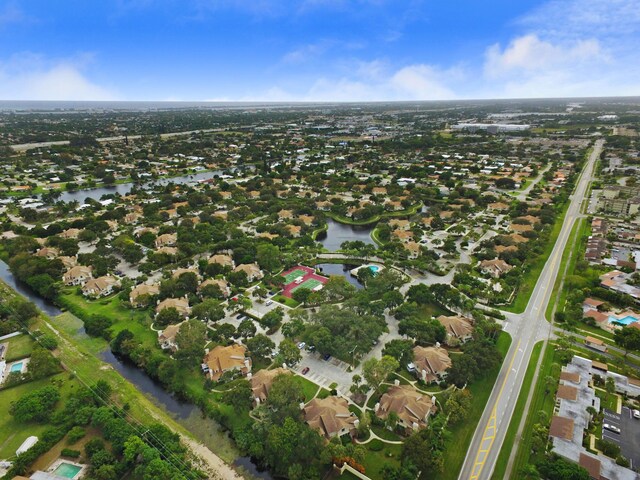 aerial overview of property's location with a nearby body of water and nearby suburban area