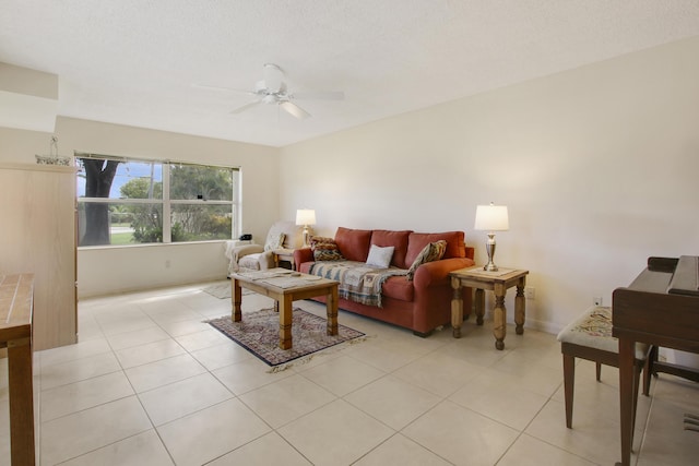 living area with light tile patterned flooring and ceiling fan
