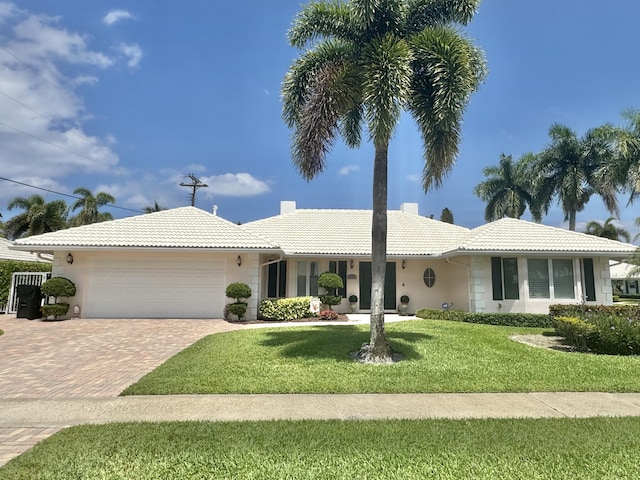 1360 SW Sugar Plum Dr, Boca Raton, FL 33486 - ranch-style house with a tile roof, an attached garage, decorative driveway, stucco siding, and a front lawn