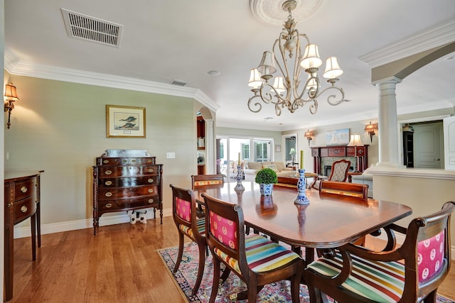 1360 SW Sugar Plum Dr, Boca Raton, FL 33486 - dining space featuring decorative columns, crown molding, light wood-style floors, baseboards, and a chandelier