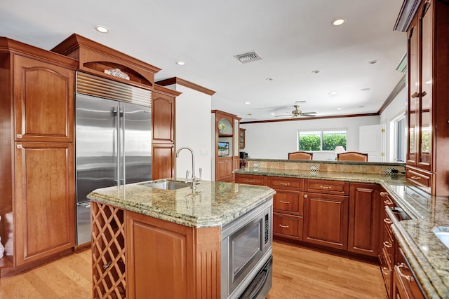 1360 SW Sugar Plum Dr, Boca Raton, FL 33486 - kitchen featuring a sink, built in appliances, crown molding, a ceiling fan, and light wood-type flooring