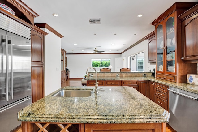 1360 SW Sugar Plum Dr, Boca Raton, FL 33486 - kitchen featuring appliances with stainless steel finishes, a sink, ceiling fan, crown molding, and light stone countertops