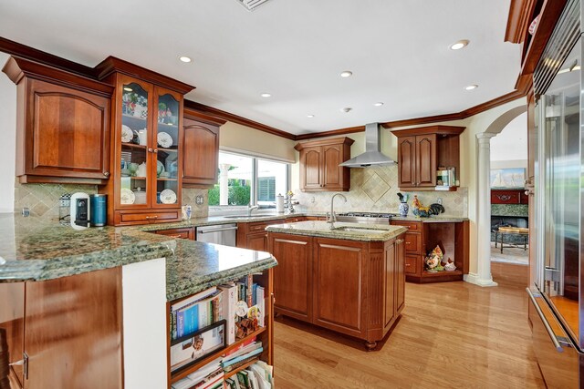1360 SW Sugar Plum Dr, Boca Raton, FL 33486 - kitchen with wall chimney exhaust hood, decorative columns, a sink, light stone counters, and crown molding