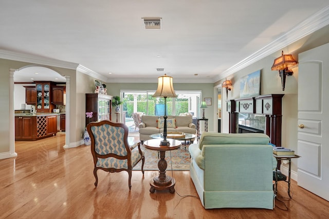 1360 SW Sugar Plum Dr, Boca Raton, FL 33486 - living room featuring light wood finished floors, a high end fireplace, crown molding, arched walkways, and baseboards