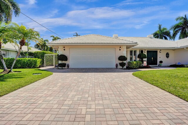 1360 SW Sugar Plum Dr, Boca Raton, FL 33486 - single story home featuring decorative driveway, a tile roof, an attached garage, and stucco siding