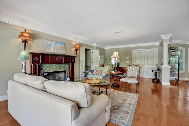 1360 SW Sugar Plum Dr, Boca Raton, FL 33486 - living area with decorative columns, crown molding, a fireplace, wood finished floors, and baseboards