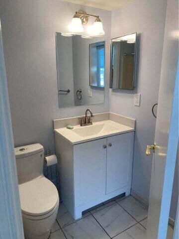 3566 N University Dr Unit F-5, Coral Springs, FL 33065 - bathroom featuring tile patterned flooring, toilet, and vanity