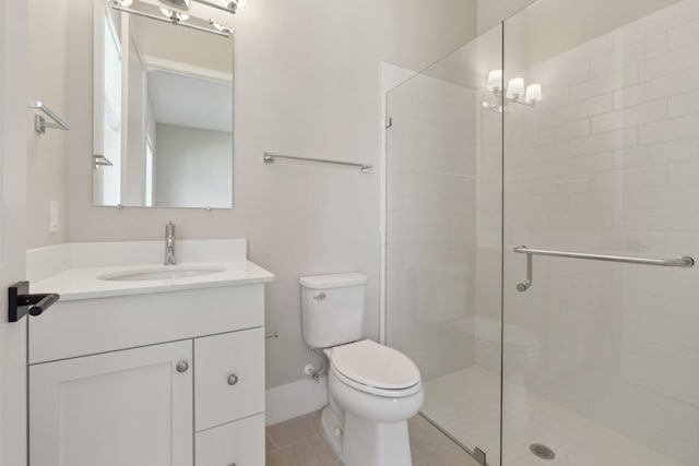 bathroom with a stall shower, toilet, vanity, and tile patterned floors