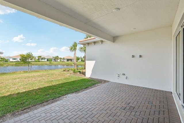 view of patio / terrace with a water view and a residential view