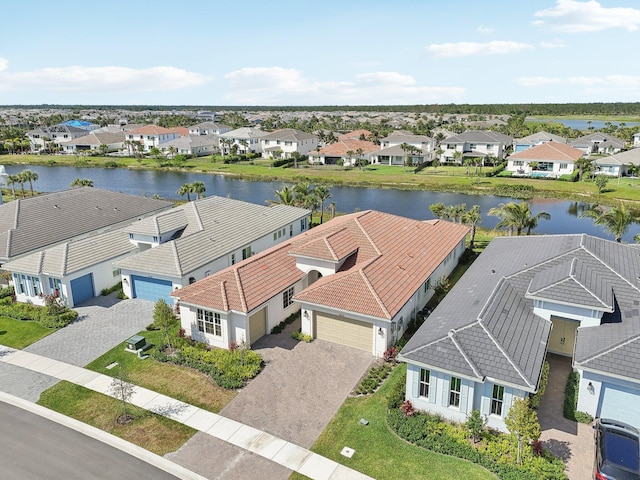 aerial view of residential area featuring a large body of water