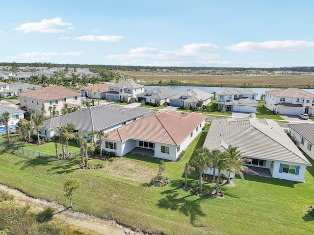 aerial view of residential area featuring a large body of water