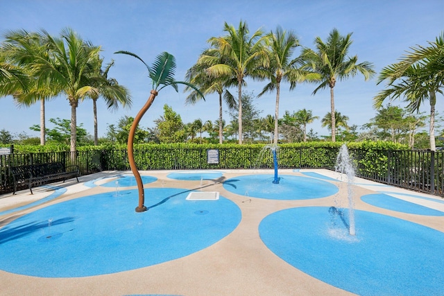 view of swimming pool featuring fence