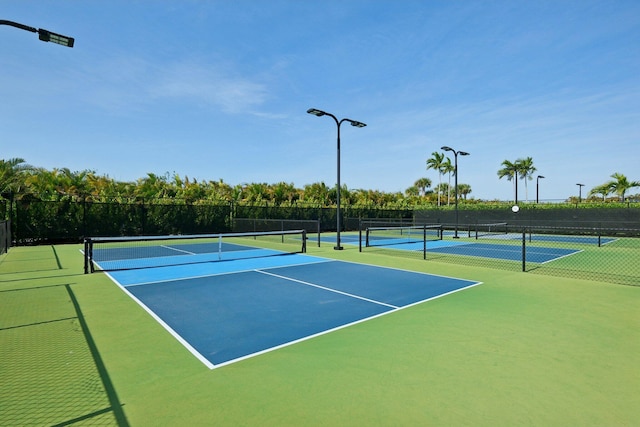 view of tennis court with fence and community basketball court